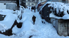 Menschen gehen auf einer schneebedeckten Straße in einem von starkem Schneefall betroffenen Gebiet in Murree. Foto: epa/Sohail Shahzad