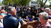 Der montenegrinische Präsident und Vorsitzende der Demokratischen Partei der Sozialisten (DPS) Milo Djukanovic (L) wird vor einem Wahllokal in Podgorica interviewt. Foto: epa/Boris Pejovic