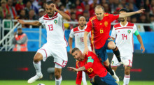 Khalid Boutaib (l.) aus Marokko im Einsatz gegen die spanischen Spieler Sergio Ramos (M.) und Andres Iniesta (r.). Foto: epa/Armando Babani