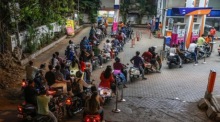 Motorradfahrer warten an einer Tankstelle in Mumbai, nachdem Premier Modi zum Sparen von Kraftstoff aufgerufen hat. Foto: EPA/Divyakant Solanki