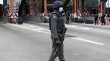 Ein Polizist geht am Lekki-Tollgate vorbei, wo Jugendliche an die tödliche Militäraktion gegen Proteste gegen Polizeigewalt erinnern. Foto: epa/Akintunde Akinleye