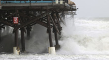 Wellen brechen am Cocoa Beach Pier, als der Sturm «Nicole» aufzieht. Foto: Ricardo Ramirez Buxeda/Orlando Sentinel/dpa