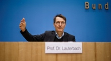 Der deutsche Gesundheitsminister Karl Lauterbach schaut während einer Pressekonferenz zu. Foto: epa/Clemens Bilan