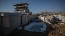 Vertriebene Palästinenser nutzen an einem heißen Sommertag in einem Zeltlager im Osten von Gaza-Stadt ein provisorisches Wasserbecken zur Abkühlung. Foto: EPA/Mohammed Saber