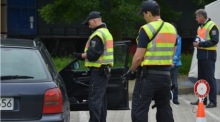 Beamte der Bundespolizei kontrollieren die Insassen eines PKWs auf einem Parkplatz an der Autobahn A 64 in der Nähe von Trier. Foto: epa/Harald Tittel