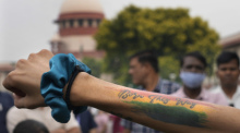 Eine Person, die die LGBTQ-Gemeinschaft unterstützt, zeigt eine Tätowierung auf ihrer Hand mit der Aufschrift «Born this way» vor dem Obersten Gerichtshof. Das Höchste Gericht in Indien hat eine Legalisierung der Hom... Foto: Manish Swarup/Ap/dpa