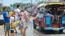 Touristen und Einheimische liefern sich während Songkran auf Koh Samui eine fröhliche Wasserschlacht entlang der Straße und nehmen sogar vorbeifahrende Songthaews ins Visier. Foto: Bangkok Airways