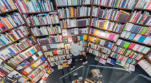 Eine Mitarbeiterin sortiert in der Buchhandlung Walther König Bücher in Regale ein. Foto: Rolf Vennenbernd/dpa