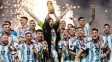 Argentinien - Frankreich, Finalrunde, Finale, Lusail Stadion. Der argentinische Nationalspieler Lionel Messi (M) feiert mit der Mannschaft den Sieg und hebt dabei die WM-Trophäe in die Höhe. Foto: Martin Meissner/Ap/dpa
