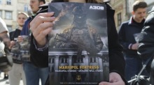 Ein ukrainischer Teilnehmer mit einem Plakat nimmt an einer Kundgebung in der Innenstadt von Lemberg teil, bei der die Freigabe der Blockade von Mariupol und die Rettung der Zivilbevölkerung und ihrer Verteidiger gefordert... Foto: epa/Mykola Tys