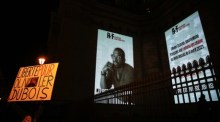 Der Mann hält ein Schild mit der Aufschrift "Freiheit für Olivier Dubois" neben einer monumentalen Projektion für den französischen Journalisten Olivier Dubois am Pantheon-Gebäude in Paris. Foto: epa/Mohammed Badra