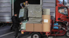 Ein Arbeiter entlädt Waren von einem Lastwagen in der Nähe eines Handelszentrums in Peking bekannt ist. Foto: epa/Wu Hong