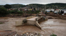 Ein Fluss fließt um eine beschädigte Brücke, nachdem schwere Regenfälle sie in der Nähe von Durban zerstört haben. Foto: epa/Str