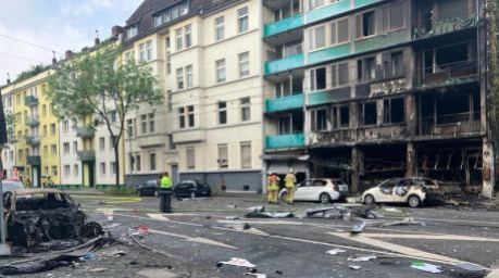 rümmer liegen auf einer Straße in Düsseldorf vor einem haus, in dem ein Brand wütete. Bei dem Brand in Düsseldorf sind mehrere Menschen ums Leben gekommen und weitere verletzt worden. Foto: Jana Glose/dpa