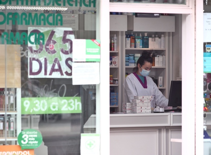 Eine Apothekerin arbeitet mit Mundschutz. Spanien ist eines der am schlimmsten von dem neuen Coronavirus betroffenen Länder, seit dem Wochenende herrscht Ausgangssperre. Foto: Eduardo Parra/Europa Press/dpa