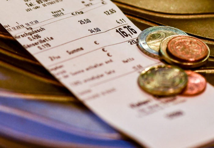 Wechselgeld liegt auf dem Kassenbon in einer Berliner Metzgerei. Foto: Jens Kalaene/Zb/dpa 