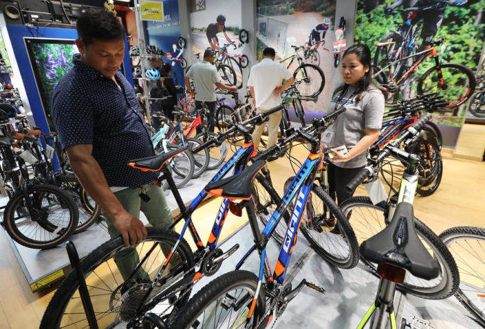 Kunden besichtigen EU-Fahrräder in einem Giant Bike Verkaufsladen in Phnom Penh. Foto: epa/Mak Remissa