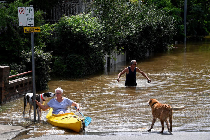 Ein Bewohner paddelt durch das Hochwasser, als eine Straße in Windsor, nordwestlich von Sydney, überflutet wird. Foto: epa/Bianca De Marchi