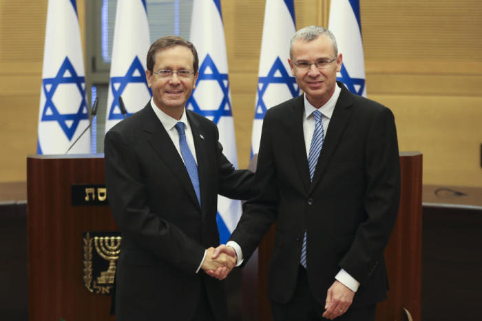 Präsidentschaftsbewerber Isaac Herzog (L) schüttelt Yariv Levin in der Knesset die Hand. Foto: epa/Ronen Zvulun