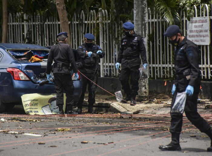 Polizisten untersuchen den Ort der Bombenexplosion vor der Herz-Jesu-Kathedrale nach einer Explosion in Makassar. Foto: epa/Lawu