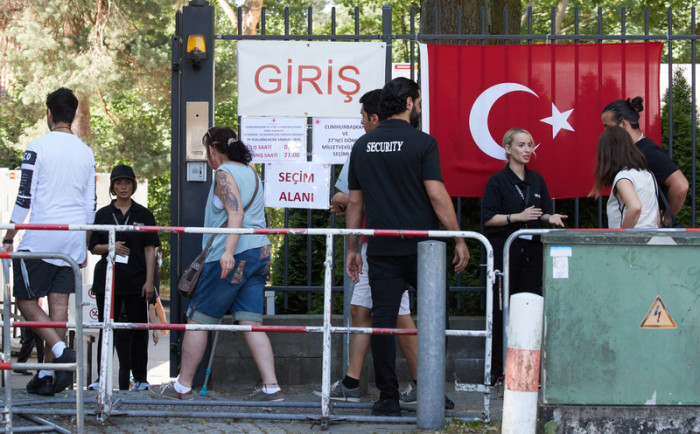 Sicherheitskräfte kontrollieren die Wahlberechtigten am Eingang des türkischen Konsulates in Berlin. Foto: epa/Hayoung Jeon