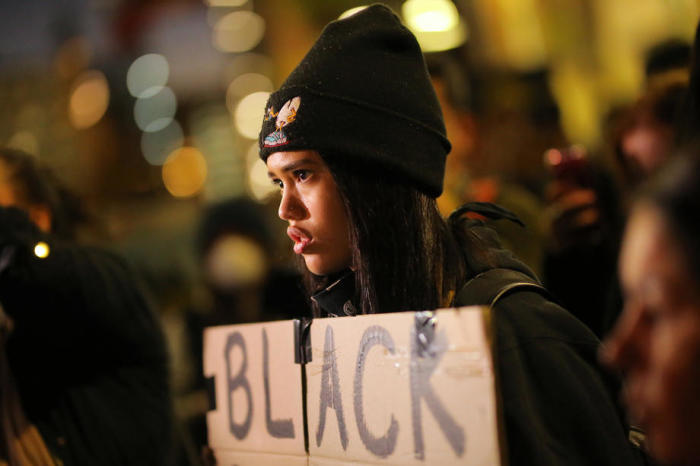 Eine Protestierende hält ein Plakat während eines Black Live Matter-Protestes nach der tödlichen Verhaftung von George Floyd in Minneapolis. Foto: epa/Stevan Saphore