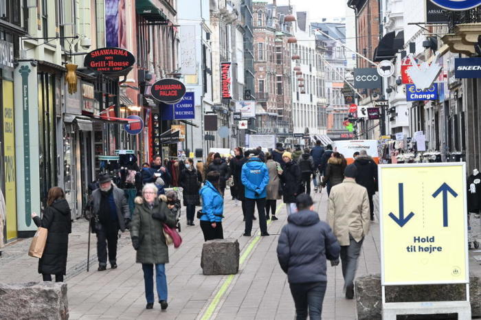 Menschen gehen vor Geschäften, die im Zentrum von Kopenhagen wieder geöffnet haben. Foto: epa/Philip Davali