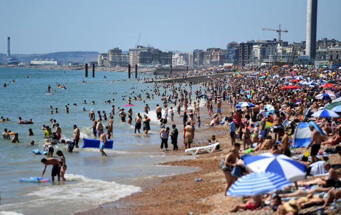 Die Menschen tanken die Sonne am Strand von Brighton in Brighton. Foto: epa/Andy Rain