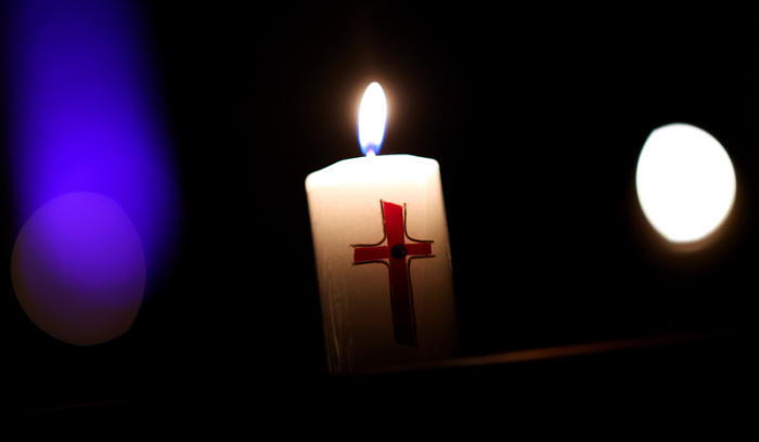 Eine Kerze brennt während der Feier zur Osternacht in der römisch-katholischen Kathedralkirche Sankt Sebastian. Knapp 35 Jahre nach dem brutalen Mord an einem deutschen Au-Pair-Mädchen in Paris. Foto: Ronny Hartmann/dpa