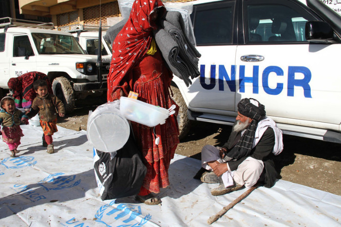 Afghanische Vertriebenenfamilien warten auf die vom UNHCR verteilten Wintersachen. Foto: epa/S. Sabawoon