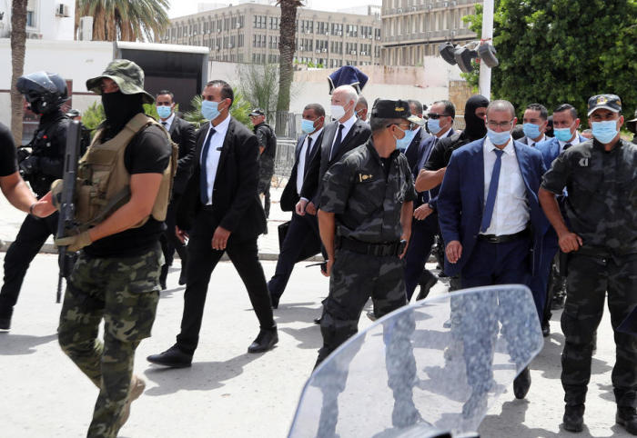 Tutesiens Präsident Kais Saied (C) geht im Schutz der Sicherheitskräfte über die zentrale Habib Bourguiba Avenue in Tunis. Foto: epa/Mohamed Messara