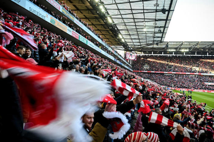 Kölns Fans stehen vor dem Bundesligaspiel auf den Tribünen dicht beieinander und jubeln. Foto: epa/Sascha Steinbach