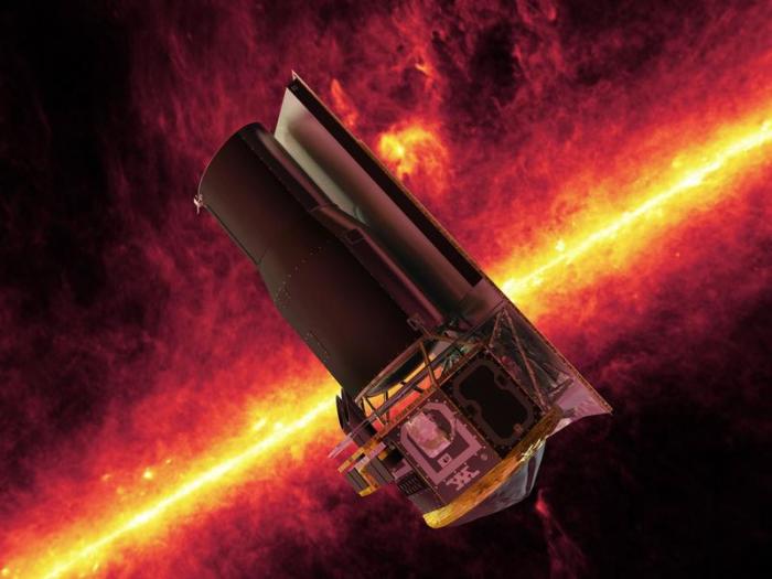 Die undatierte künstlerische Darstellung zeigt das «Spitzer»-Weltraumteleskop vor einer Infrarotaufnahme der Milchstraße die von dem Teleskop gemacht wurde. Foto: NASA/Jpl/dpa