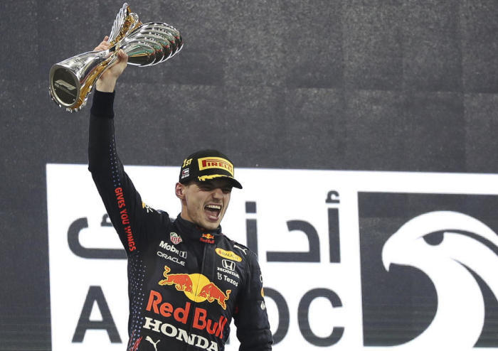 Max Verstappen, niederländischer Formel-1-Pilot von Red Bull Racing, jubelt nach seinem Sieg beim Großen Preis von Abu Dhabi 2021 auf dem Podium. Foto: epa/Ali Haider