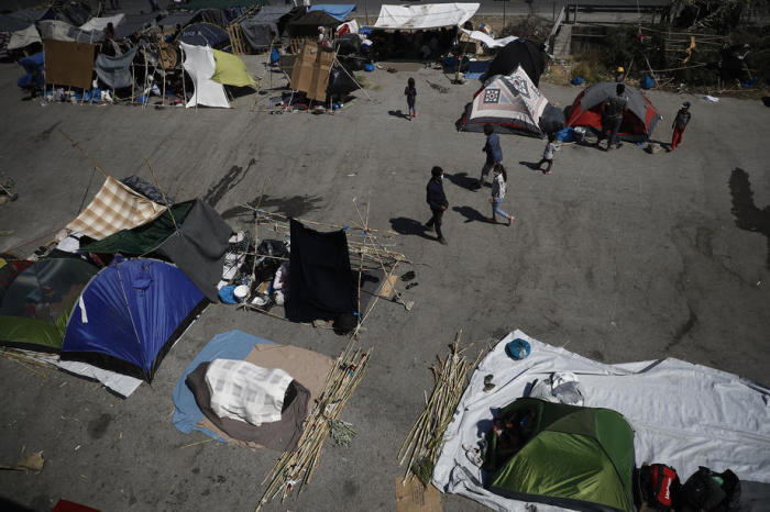 Asylsuchende aus dem zerstörten Lager Moria finden Schutz an einer Straße in der Nähe eines neuen provisorischen Lagers, Mytilene. Foto: epa/Dimitris Tosidis