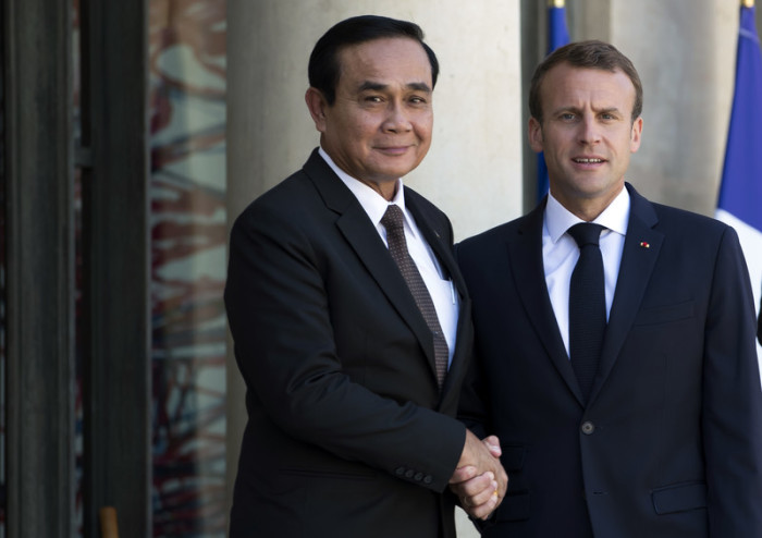 Thailands Premierminister Prayut Chan-o-cha (l.)und Frankreichs Präsident Emmanuel Macron (r.). Foto: epa/Ian Langsdon