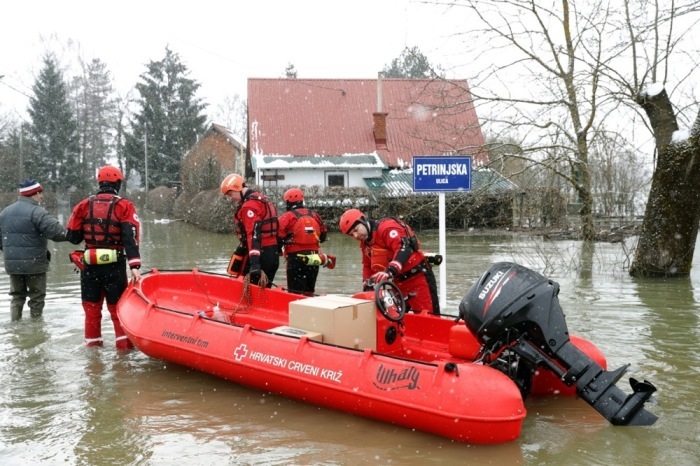 Mitarbeiter des Kroatischen Roten Kreuzes helfen Menschen, die vom Hochwasser des Flusses Kupa im Dorf Zazina eingeschlossen sind. Foto: epa/Antonio Bat