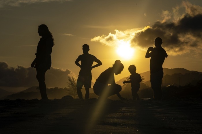 Die Familie genießt den Sonnenuntergang am Strand von Camboinhas in Niteroi. Foto: epa/Antonio Lacerda