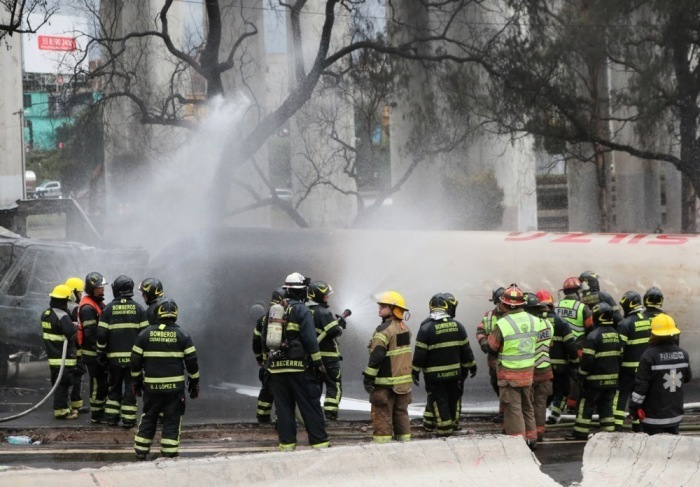 Explosion eines Gastanklasters in Mexiko-Stadt Feuerwehrleute bekämpfen Flammen nach Explosion eines Lastwagens – drei Tote, 70 Verletzte gemeldet. Foto: epa/Mario Guzman