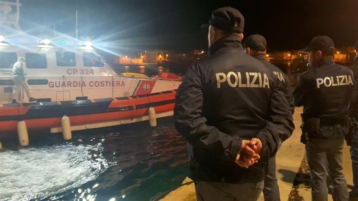 Polizisten warten am Hafenkai auf das Boot mit den Leichen von 8 Migranten in Lampedusa. Foto: epa/Concetta Rizzo