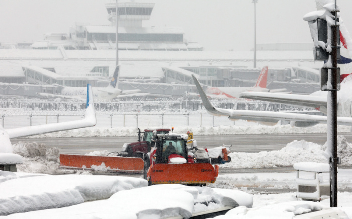 Räum- und Streufahrzeuge fahren im Schneetreiben auf dem Flughafen. Die Sperrung des Flugbetriebes am Münchner Flughafen ist wegen starker Schneefälle bis 03.12.2023 um 6.00 Uhr verlängert worden. Foto: Karl-Josef Hildenbrand/dpa