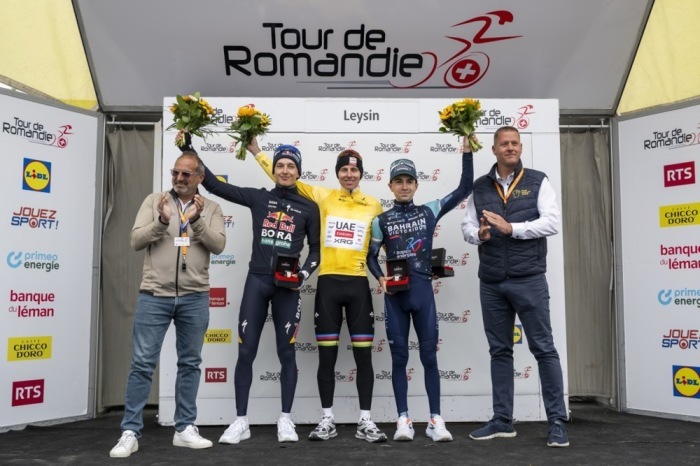 Tadej Pogačar feiert den Gesamtsieg bei der Tour de Romandie vor Florian Lipowitz und Lenny Martinez. Foto: EPA/Jean-christophe Bott