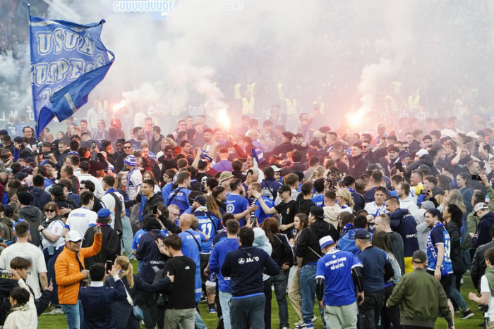 Darmstadts Fans feiern auf dem Spielfeld den Aufstieg in die 1. Bundesliga. Foto: Uwe Anspach/dpa