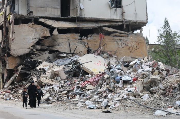 Menschen gehen durch Trümmer in Jibchit im Südlibanon nach Luftangriffen. Eine zehntägige Waffenruhe zwischen Israel und Libanon gilt. Foto: epa/Wael Hamzeh