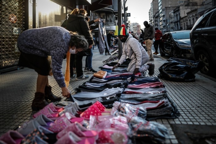 Migranten aus dem Senegal verkaufen Produkte auf der Straße im Viertel Once in Buenos Aires. Foto: epa/Juan Ignacio Roncoroni