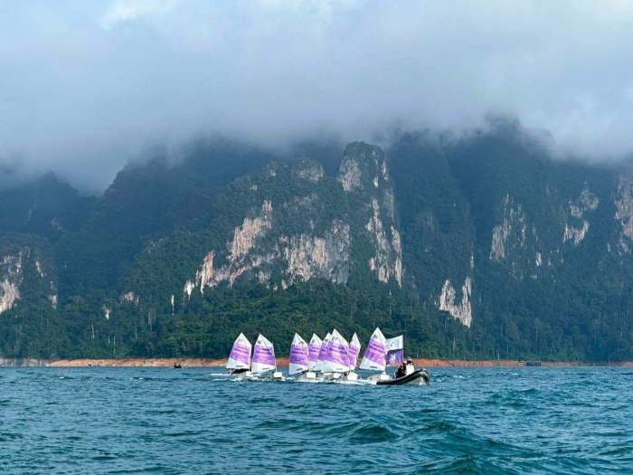 Teilnehmer der Segelregatta steuern ihre Optimist-Jollen vor der markanten Karstkulisse des Ratchaprapha-Stausees in Surat Thani. Bild: JS100 Radio