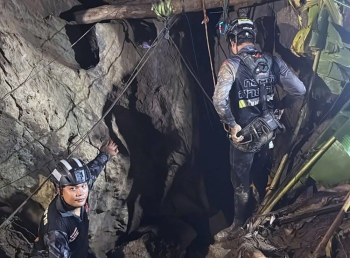 Retter erkunden einen neu entdeckten Zugang zu dem überfluteten Höhlensystem in der laotischen Provinz Xaisomboun, in dem noch zwei Goldsucher vermisst werden. Foto: epa/Metta Tham Kalasin Rescue