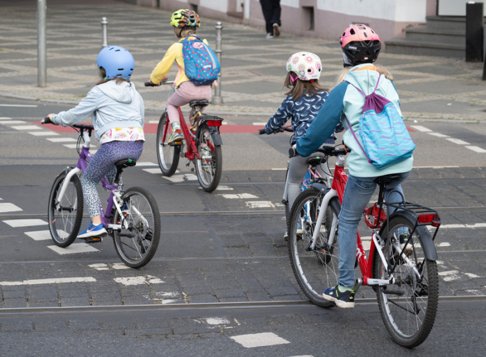 In einem Konvoi fahren Kinder und Erwachsene auf ihren Fahrrädern durch das Frankfurter Nordend. Foto: Boris Roessler/dpa