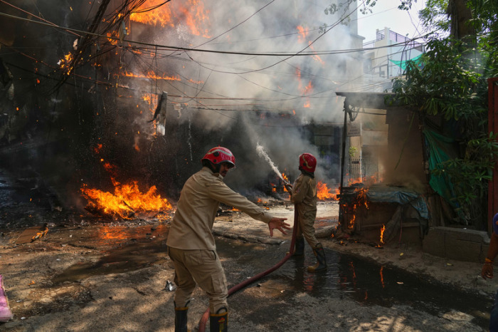 Feuerwehrkräfte bekämpfen einen Brand in einem Hotel in Neu-Delhi, bei dem mehrere Menschen ums Leben kamen. Foto: dpa/Manish Swarup Via Ap