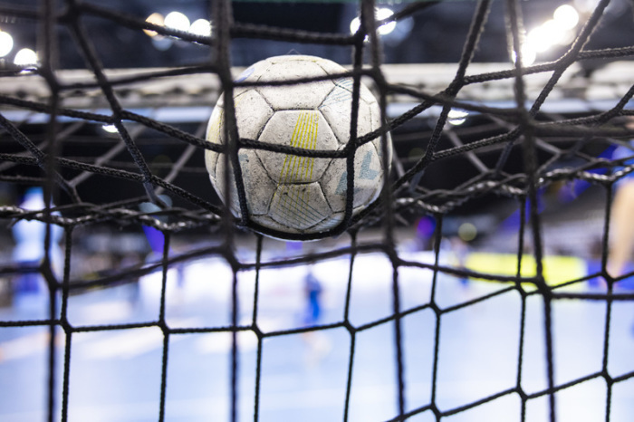 Ein Handball liegt auf einem Tornetz. Foto: Tom Weller/dpa